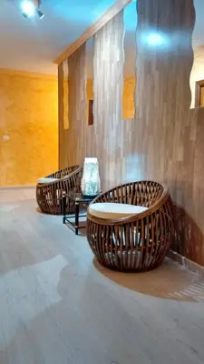 three wicker chairs and a table in a room at Hotel Restaurante America in Oca