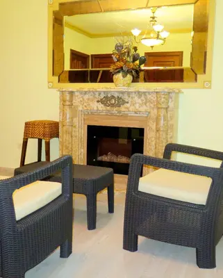 a living room with two chairs and a fireplace at Hotel Restaurante America in Oca