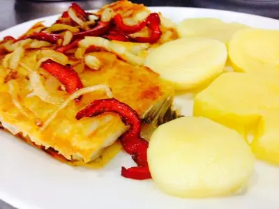 a white plate of food with waffles and potatoes at Hotel Restaurante America in Oca