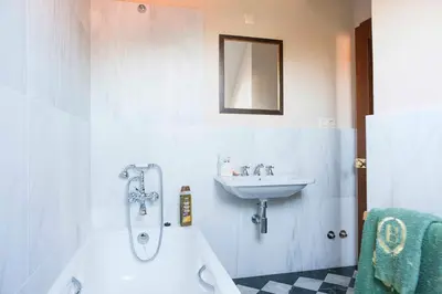 a bathroom with a sink and a bath tub and a sink at Pazo de Brandeso & Country Club in Arzúa