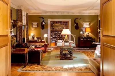 a living room with a couch and a table at Pazo de Brandeso & Country Club in Arzúa