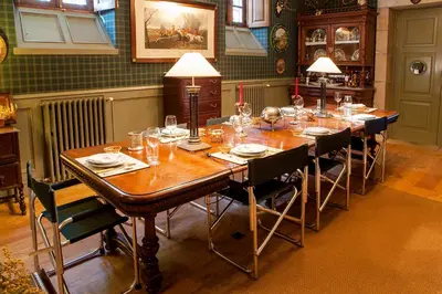 a dining room with a long table with glasses on it at Pazo de Brandeso & Country Club in Arzúa