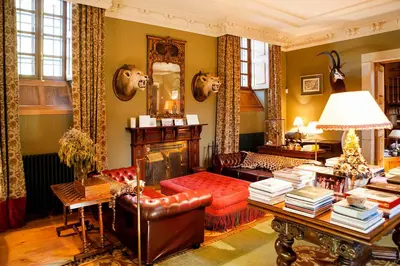 a living room with a couch and a table at Pazo de Brandeso & Country Club in Arzúa