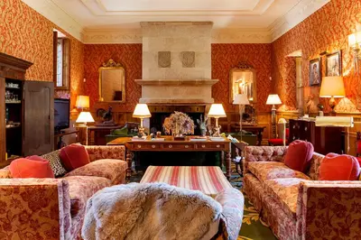 a living room with two couches and a fireplace at Pazo de Brandeso & Country Club in Arzúa