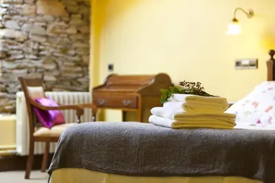a pile of towels sitting on a bed with a piano at Finca Goleta in Foz
