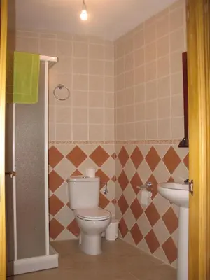 a bathroom with a toilet and a sink at Casa Rural La Dama del Alba in Vega de Magaz