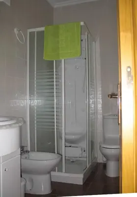 a bathroom with a shower and a toilet and a sink at Casa Rural La Dama del Alba in Vega de Magaz