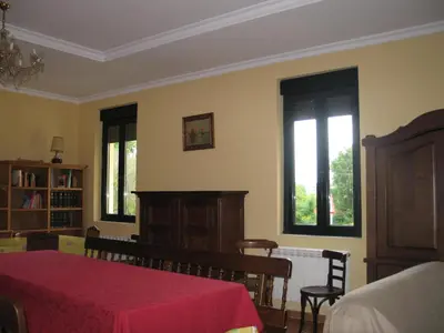 a bedroom with a bed and two windows at Casa Rural La Dama del Alba in Vega de Magaz