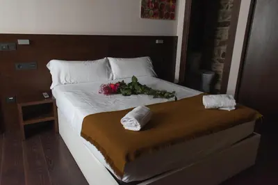 a bedroom with a bed with flowers on it at Pensión A Casa do Peregrino in Santiago de Compostela