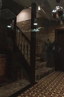 a staircase in a room with a stone wall at Pensión A Casa do Peregrino in Santiago de Compostela