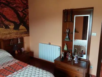 a bedroom with a bed and a dresser and a mirror at Casa Socorro in A Estrada