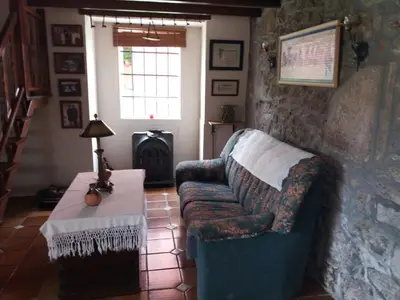 a living room with a couch and a table at Casa Socorro in A Estrada