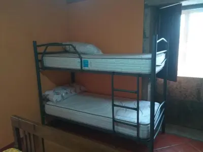 two bunk beds in a room with a window at Casa Socorro in A Estrada