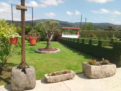 a garden with two flower pots and a pole at Casa Socorro in A Estrada