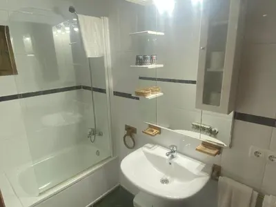 a bedroom with a bed and a stone wall at Hotel Rural Camino Medulas in Ponferrada