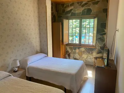 a bathroom with a tub and a toilet and a sink at Hotel Rural Camino Medulas in Ponferrada