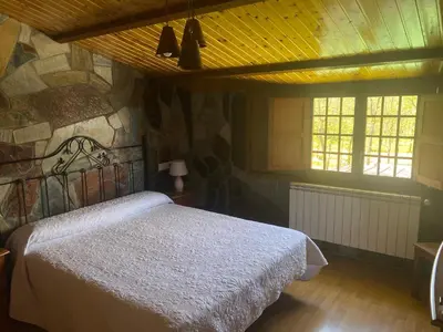 a bathroom with a tub and a toilet and a sink at Hotel Rural Camino Medulas in Ponferrada