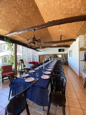 a long dining room with a long table and chairs at Fogar de Insua in Touro