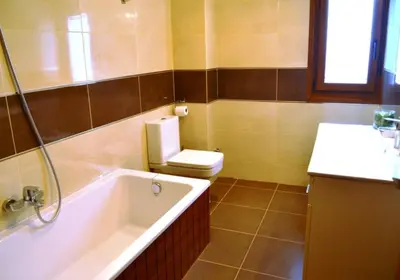 a bathroom with a tub and a toilet and a sink at Fogar de Insua in Touro