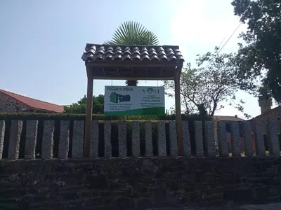 a wooden fence with a sign on top of it at Fogar de Insua in Touro
