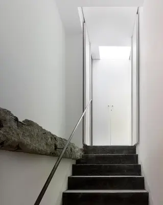 a staircase leading up to a white building with a door at Moure Hotel in Santiago de Compostela