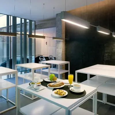 a dining room with a table with food on it at Moure Hotel in Santiago de Compostela