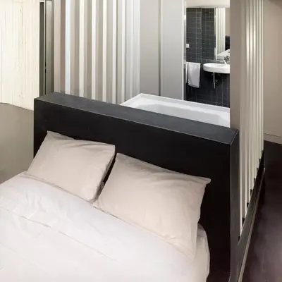 a bedroom with a bed and a bath tub at Moure Hotel in Santiago de Compostela