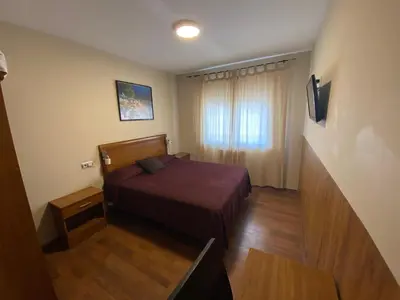 a small room with a bed and a window at dpCristal in Sarria