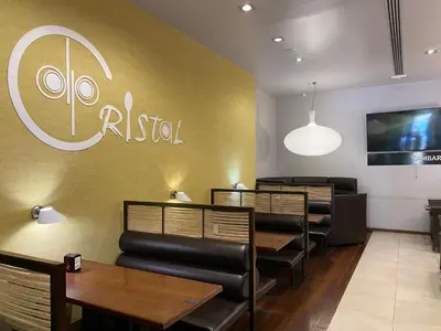 a restaurant with tables and chairs and a sign on the wall at dpCristal in Sarria