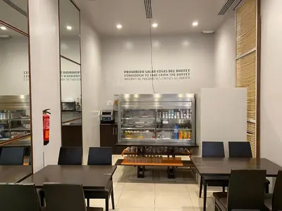 a restaurant with tables and chairs and a refrigerator at dpCristal in Sarria