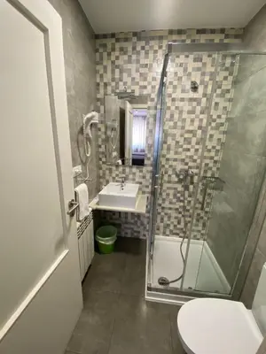 a bathroom with a shower and a sink and a toilet at dpCristal in Sarria