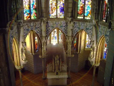 a church with a altar and stained glass windows at La Lechería in Val de San Lorenzo