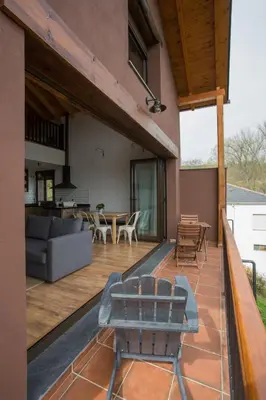 an outdoor patio with a couch and a table at Os Feleitos in Orellán