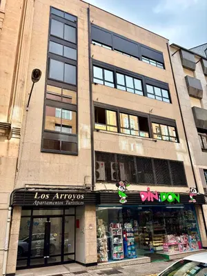 a store front of a building on a street at Apartamentos Los Arroyos in Ponferrada