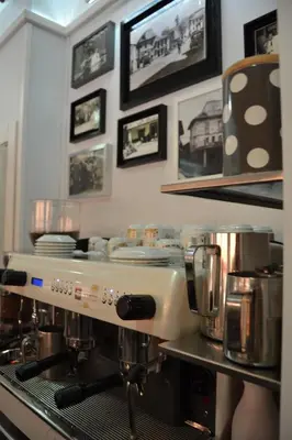 a kitchen with a coffee machine on a counter at Hostal Carlos V in Puebla de Sanabria