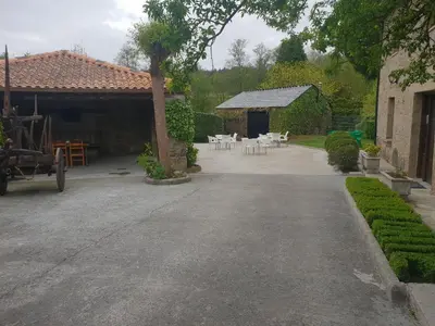 a driveway of a house with a table and chairs at Casa da Ponte in Ferreira