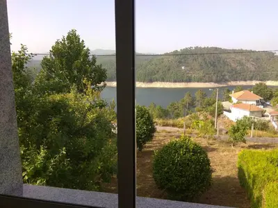 a view of a lake from a window at Secondary home in Lobios