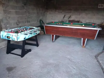 two pool tables sitting next to a brick wall at Secondary home in Lobios