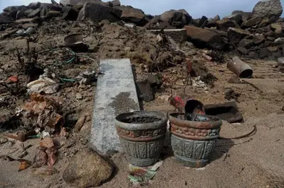 two pots sitting on top of a pile of rubble at Secondary home in Lobios
