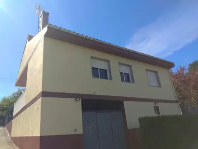 a large white house with a garage at Secondary home in Lobios