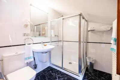 a bathroom with a shower and a sink at PENSION CASA MIÑO in Pola de Somiedo