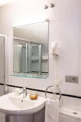 a bathroom with a sink and a mirror at PENSION CASA MIÑO in Pola de Somiedo