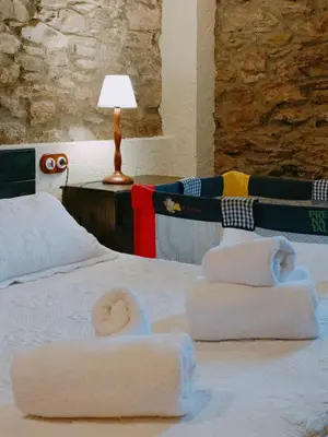 a bedroom with a bed with towels on it at La Cabana´l Cachican in Cangas del Narcea