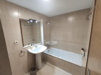a bathroom with a sink and a bath tub at Casa Riquiña in Santiago de Compostela