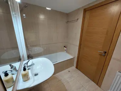 a bathroom with a sink and a bath tub at Casa Riquiña in Santiago de Compostela