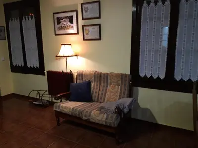 a living room with a chair and a lamp at Hotel Rural Molino del Arriero in Luyego de Somoza