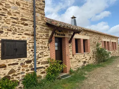 an old stone building with a door at Hotel Rural Molino del Arriero in Luyego de Somoza