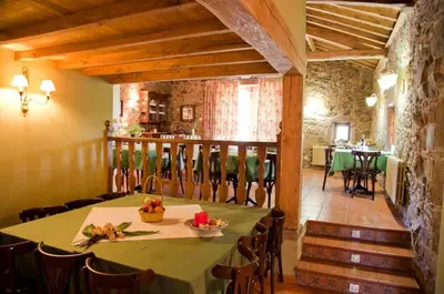 a dining room with a green table and chairs at A Casa da Torre Branca in Santiago de Compostela