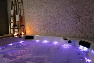 a purple bath tub with lights in a bathroom at Via Aetcal Hotel & Wellness in Santiago de Compostela