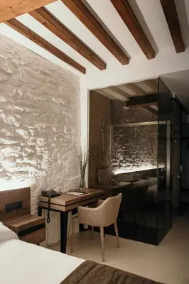 a bedroom with a desk and a bedroom with a bed at Via Aetcal Hotel & Wellness in Santiago de Compostela